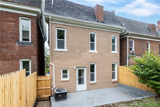 rear view of house featuring cooling unit and a patio area