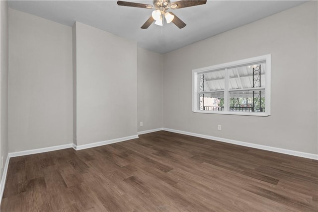 empty room with dark wood-type flooring and ceiling fan