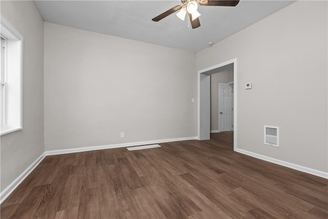 empty room featuring ceiling fan and dark hardwood / wood-style flooring