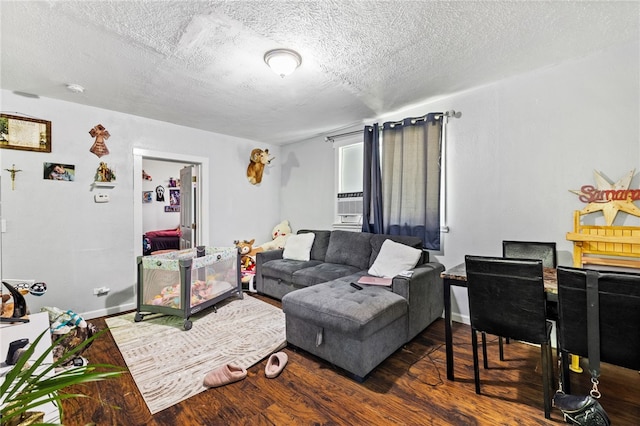 living room featuring dark hardwood / wood-style flooring and a textured ceiling