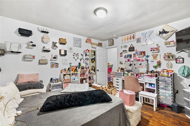 bedroom with dark hardwood / wood-style flooring