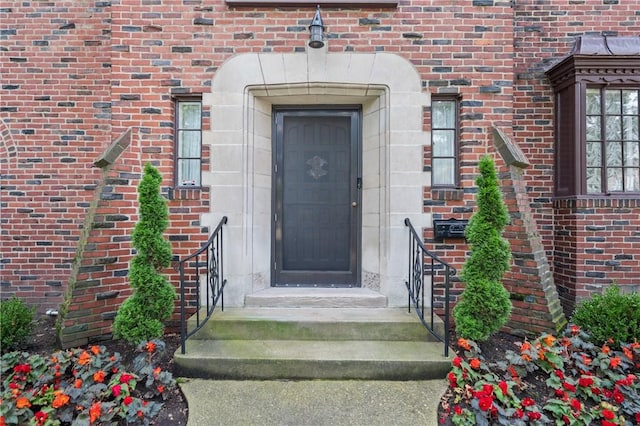 doorway to property with brick siding