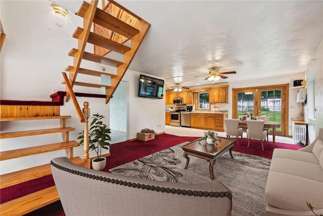 living room featuring ceiling fan, radiator, and french doors