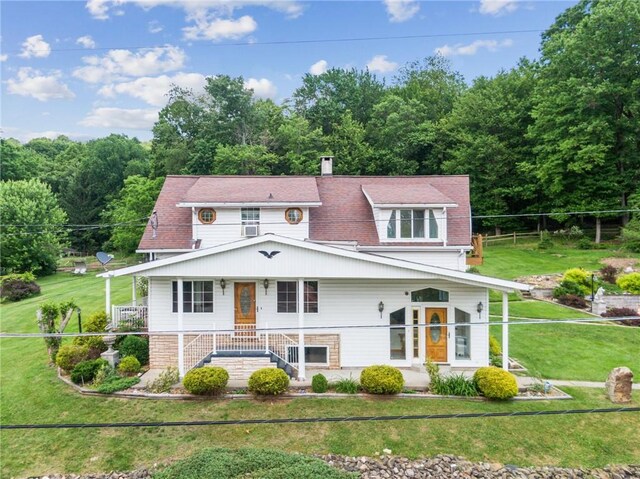 view of front of house featuring covered porch and a front lawn