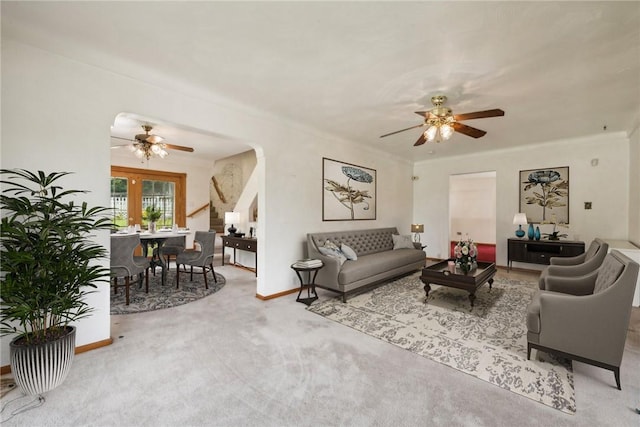 living room with ceiling fan and carpet flooring