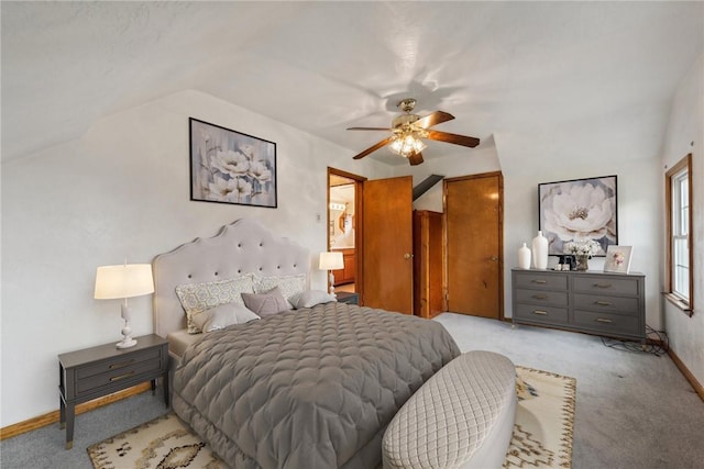 carpeted bedroom with ceiling fan and vaulted ceiling