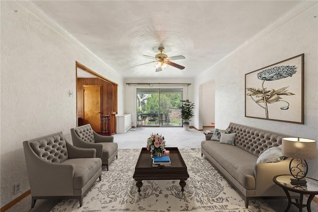 carpeted living room with ceiling fan