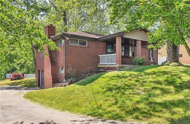 view of front of property with a garage and a front lawn