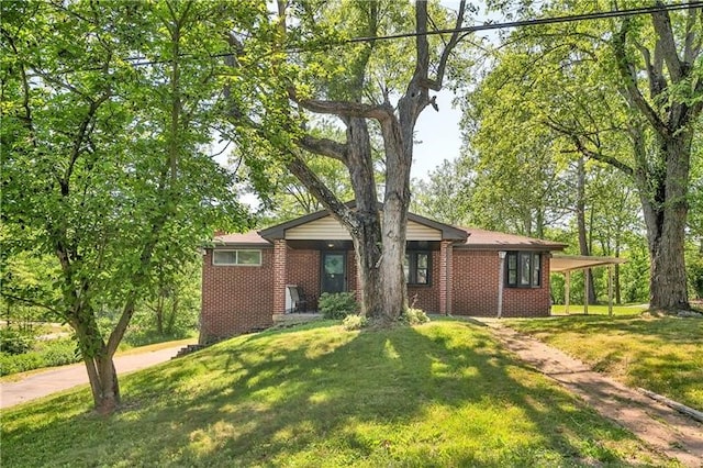 ranch-style home with a front lawn and a carport