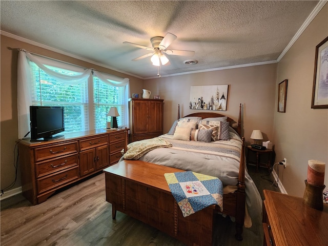 bedroom with ceiling fan, wood-type flooring, ornamental molding, and a textured ceiling