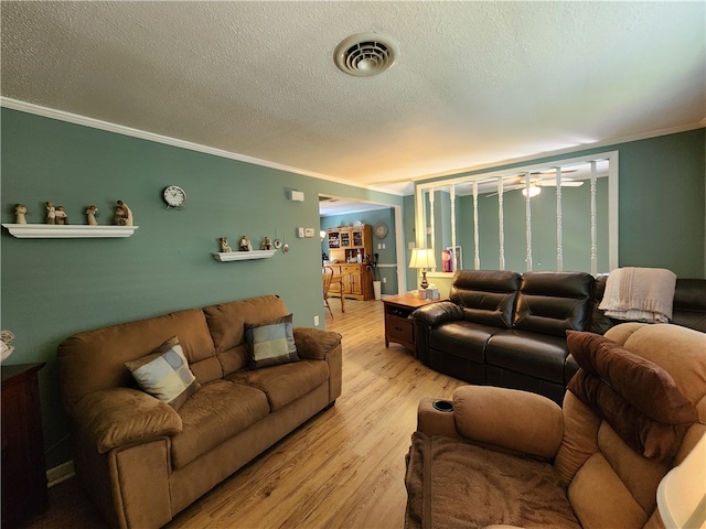 living room featuring crown molding, a textured ceiling, and light hardwood / wood-style floors