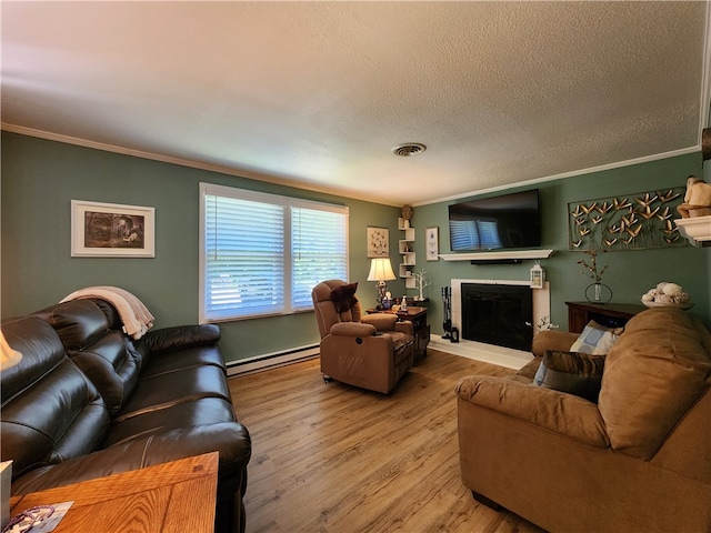 living room with a baseboard radiator, hardwood / wood-style floors, crown molding, and a textured ceiling