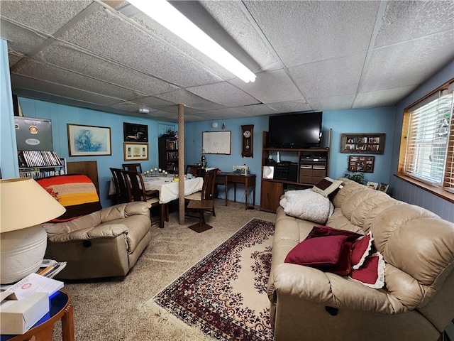 living room featuring a drop ceiling and carpet flooring