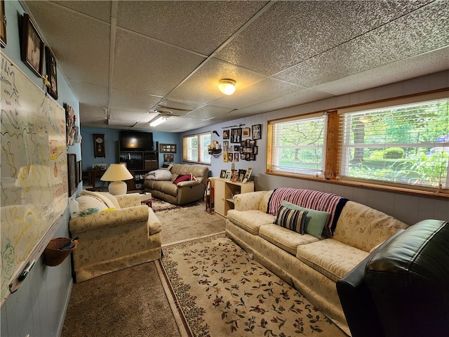 living room featuring carpet floors and a paneled ceiling