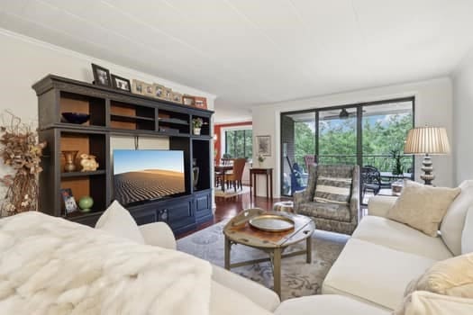 living room featuring hardwood / wood-style floors and crown molding