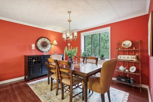 dining area featuring dark hardwood / wood-style floors, ornamental molding, and a chandelier