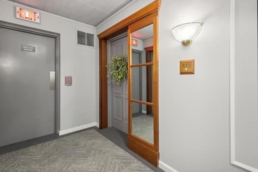 hallway with dark carpet