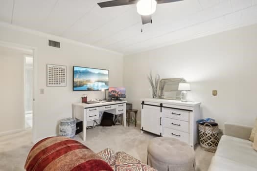 living room featuring light carpet and ceiling fan