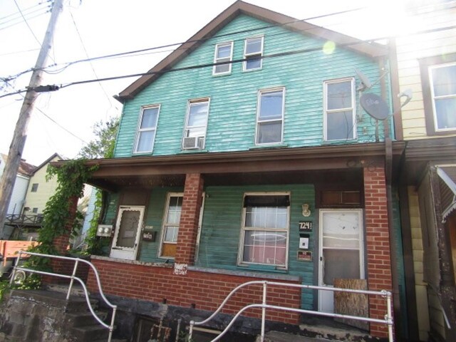 view of front of home with cooling unit and a porch