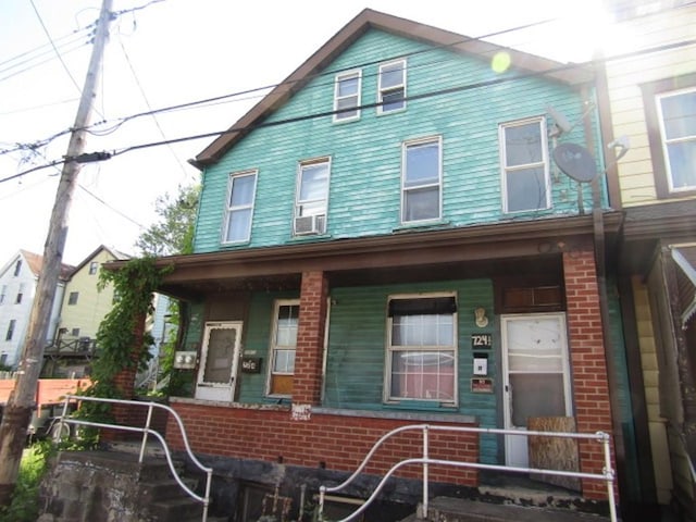 view of front of house with covered porch and brick siding