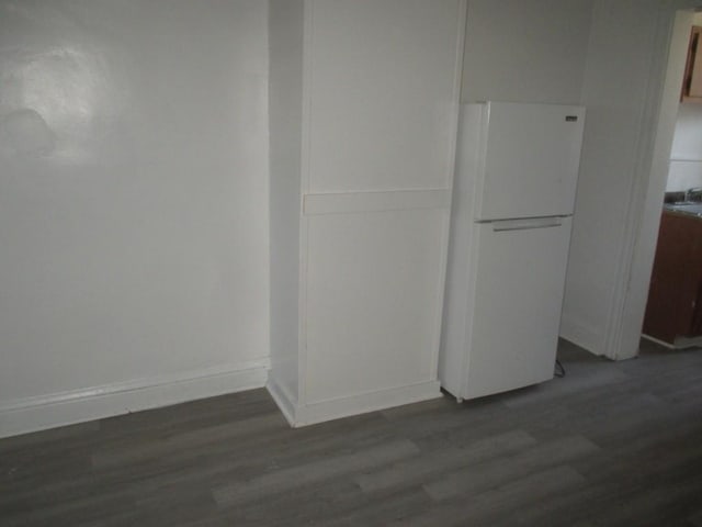 interior space featuring dark wood finished floors and baseboards