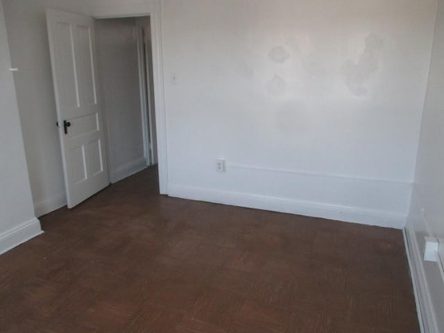 spare room featuring baseboards