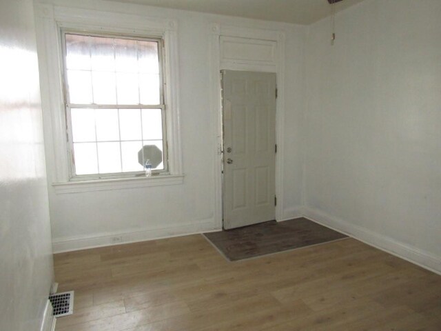 entrance foyer with light wood-type flooring, visible vents, and baseboards