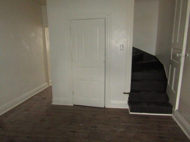 stairs with baseboards and wood finished floors