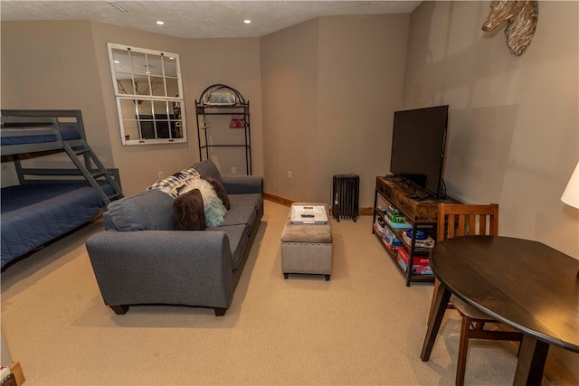 carpeted living room featuring a textured ceiling and radiator heating unit