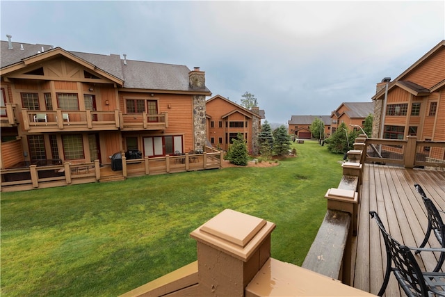 view of yard featuring a deck and a balcony