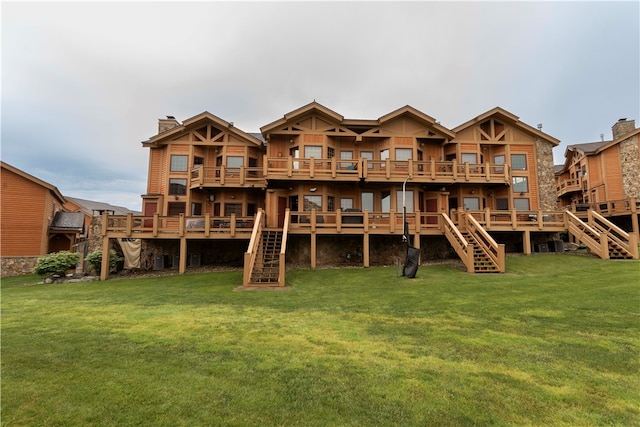 back of house with a yard and a wooden deck