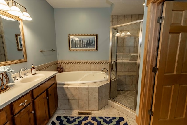 bathroom with shower with separate bathtub, tile flooring, and vanity