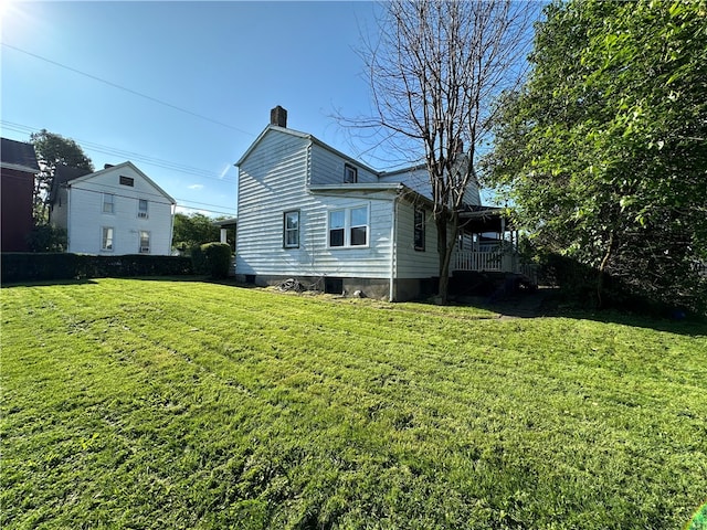 rear view of house featuring a yard