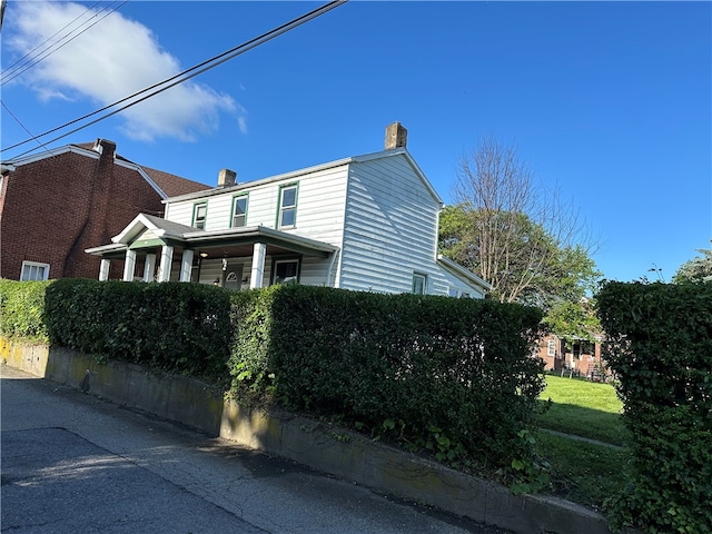 view of property exterior with a lawn