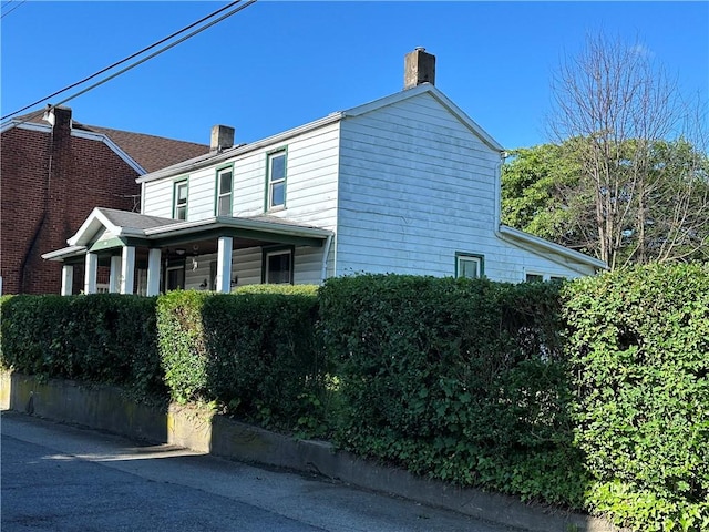 view of side of home with a chimney