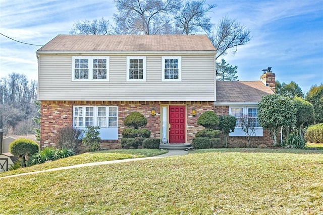 colonial-style house with a front yard, brick siding, and a chimney