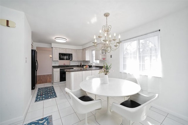 dining room with a notable chandelier, light tile patterned floors, and baseboards