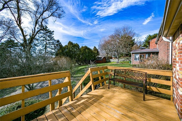 deck with an outdoor structure and a yard