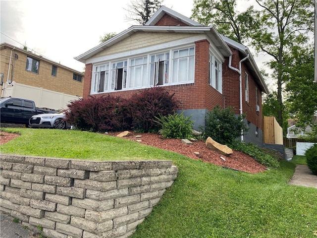 view of side of property with a yard