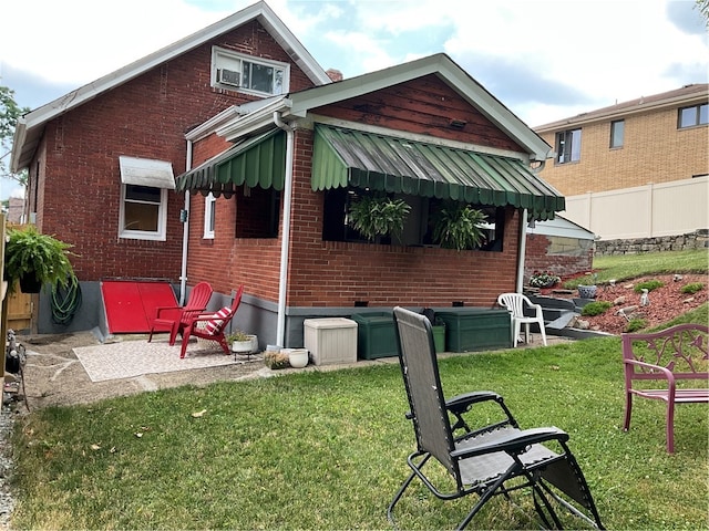 rear view of house with a yard and a patio area