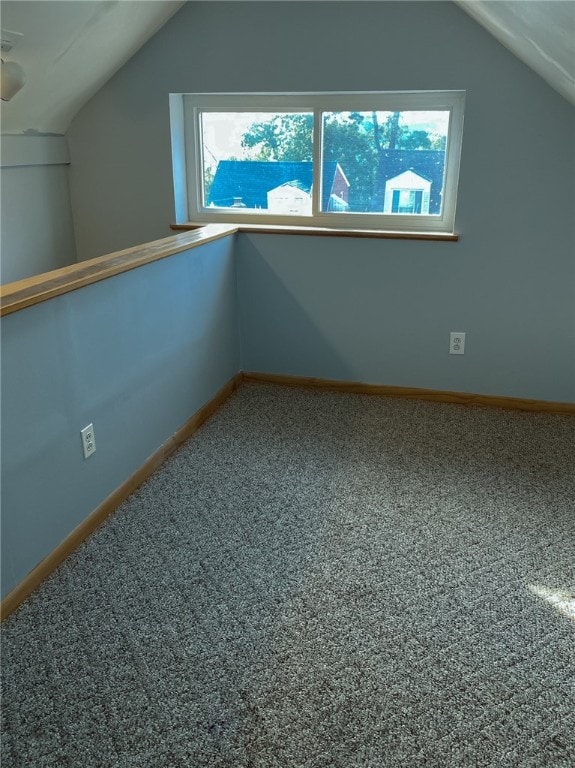 bonus room featuring a healthy amount of sunlight, carpet, and vaulted ceiling