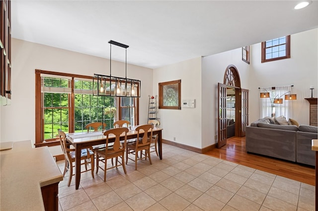 dining area featuring a notable chandelier and light tile floors