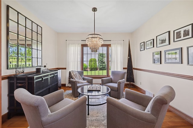 living room featuring a chandelier and hardwood / wood-style floors