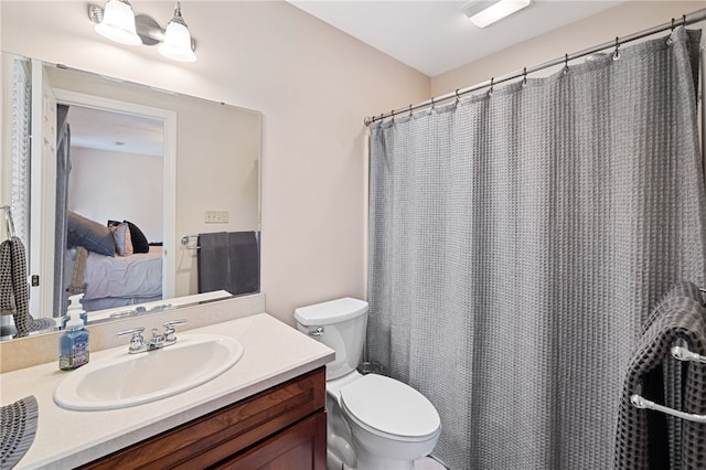 bathroom featuring toilet and vanity