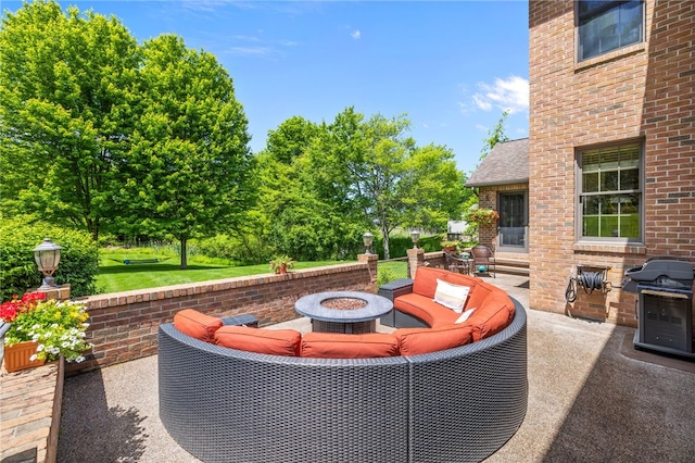 view of patio / terrace with a fire pit and area for grilling