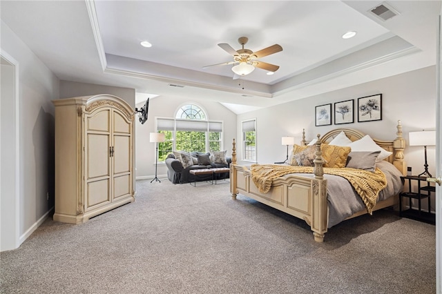 bedroom with carpet, ceiling fan, and a raised ceiling