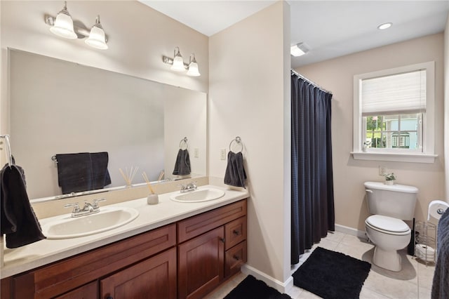 bathroom featuring tile flooring, dual vanity, and toilet