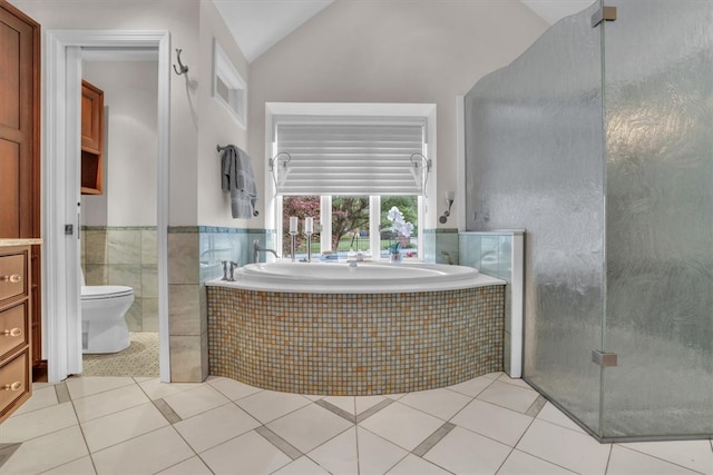 bathroom featuring toilet, tile floors, high vaulted ceiling, tiled bath, and vanity