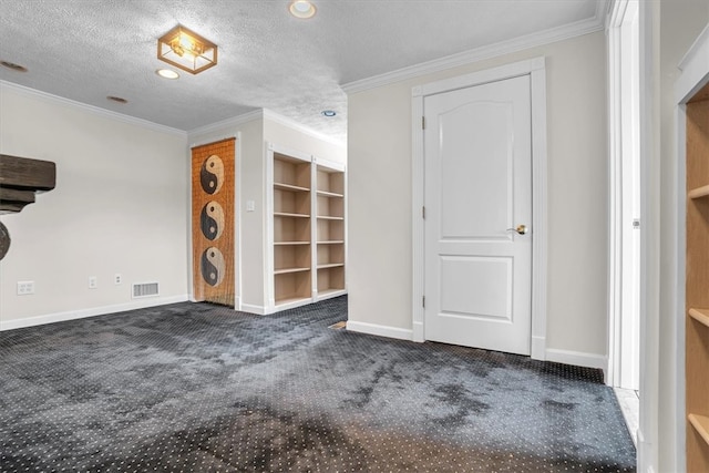 spare room with dark carpet, a textured ceiling, and crown molding