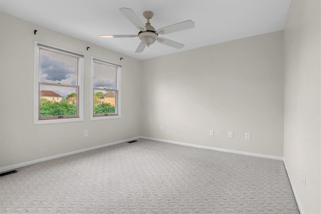 carpeted empty room featuring ceiling fan